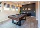 Spacious game room featuring a pool table, large windows, and tile flooring at 22837 E Orchard Ln, Queen Creek, AZ 85142