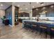 Spacious kitchen boasts dark wood cabinetry, granite countertops, and a large central island with bar seating at 22837 E Orchard Ln, Queen Creek, AZ 85142