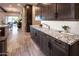 A modern kitchen features granite counters, custom wood cabinets, and lots of countertop space at 22837 E Orchard Ln, Queen Creek, AZ 85142