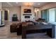 Stunning living room with a stone fireplace, modern lighting, and access to outdoor living space at 22837 E Orchard Ln, Queen Creek, AZ 85142