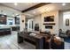 Open-concept living room and kitchen with stainless steel appliances, a fireplace, and modern design at 22837 E Orchard Ln, Queen Creek, AZ 85142