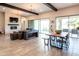 Bright living room with wood beams, fireplace, access to the backyard, and a cozy dining area at 22837 E Orchard Ln, Queen Creek, AZ 85142