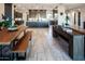 Open-concept living space with dining table, island seating, and plenty of natural light at 22837 E Orchard Ln, Queen Creek, AZ 85142