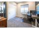 Bright office featuring a large window, a modern desk, and closet with sliding doors at 22837 E Orchard Ln, Queen Creek, AZ 85142