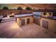 Well-equipped outdoor kitchen with a built-in grill and countertop seating at 22837 E Orchard Ln, Queen Creek, AZ 85142