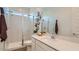 A modern bathroom featuring a glass-enclosed shower and white vanity with solid surface counters at 23256 W Tamarisk Ave, Buckeye, AZ 85326