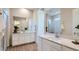 Stylish bathroom featuring dual vanities, sleek countertops, and a well-lit mirror for a contemporary feel at 23256 W Tamarisk Ave, Buckeye, AZ 85326