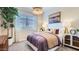 A cozy bedroom with natural light from a window, a plush bed and decor at 23256 W Tamarisk Ave, Buckeye, AZ 85326