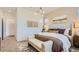 Cozy bedroom with neutral tones, stylish lighting, and a comfortable bed with decorative pillows at 23256 W Tamarisk Ave, Buckeye, AZ 85326