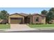 Charming single-story home features a two-car garage and a mix of stucco and stone accents at 23256 W Tamarisk Ave, Buckeye, AZ 85326