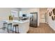 Modern kitchen with stainless steel appliances, a quartz countertop island, and bar stool seating at 23256 W Tamarisk Ave, Buckeye, AZ 85326