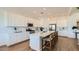 Bright kitchen with island, stainless steel appliances, and white cabinets at 23256 W Tamarisk Ave, Buckeye, AZ 85326