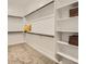 Spacious walk-in closet with ample shelving and hanging space for organized storage at 23256 W Tamarisk Ave, Buckeye, AZ 85326