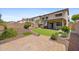 Landscaped backyard featuring a mini-golf course, patio, and lush greenery, perfect for outdoor entertainment at 2511 W Blue Sky Dr, Phoenix, AZ 85085