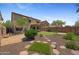 Expansive backyard featuring a mini golf course, lush landscaping, and a cozy covered patio, ideal for relaxation at 2511 W Blue Sky Dr, Phoenix, AZ 85085