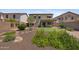 Large backyard featuring a mini golf course, patio, and lush landscaping, ideal for relaxation at 2511 W Blue Sky Dr, Phoenix, AZ 85085