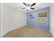 Bedroom with blue accent wall, car decal, carpet floor, and window at 2511 W Blue Sky Dr, Phoenix, AZ 85085