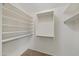 Walk-in closet with carpet flooring and shelves and bars for hanging clothes at 2511 W Blue Sky Dr, Phoenix, AZ 85085