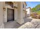 Close up of a quaint front porch with a secure, decorative door and manicured landscaping at 2511 W Blue Sky Dr, Phoenix, AZ 85085