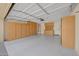 Spacious three-car garage with ample storage cabinets and epoxy flooring providing a clean, organized space at 2511 W Blue Sky Dr, Phoenix, AZ 85085