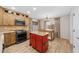 Spacious kitchen with wooden cabinets, stainless steel appliances and a center red island at 2511 W Blue Sky Dr, Phoenix, AZ 85085