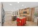 Bright eat-in kitchen with a red island, farm sink, stainless dishwasher, and tile flooring at 2511 W Blue Sky Dr, Phoenix, AZ 85085