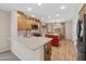 Bright kitchen featuring wooden cabinets, a center island, and hardwood style floors at 2511 W Blue Sky Dr, Phoenix, AZ 85085