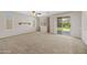 Bright living room features carpet, large windows, and a glass slider to the backyard at 2511 W Blue Sky Dr, Phoenix, AZ 85085