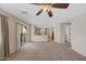 Open-concept space with a carpeted living room area leading to a well-lit kitchen at 2511 W Blue Sky Dr, Phoenix, AZ 85085