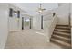 Bright living room showcasing soaring ceilings, carpet floors, and a staircase to upper floor at 2511 W Blue Sky Dr, Phoenix, AZ 85085