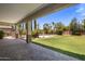 Covered patio looking out to a spacious backyard with pool at 2614 E Carob Dr, Gilbert, AZ 85298