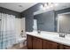 Bathroom featuring double sink vanity, shower, and toilet at 2614 E Carob Dr, Gilbert, AZ 85298