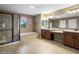 Primary bath with tiled floors, double sinks, vanity, shower, and soaking tub at 2614 E Carob Dr, Gilbert, AZ 85298
