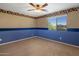 Bright bedroom with carpet flooring, ceiling fan, and large window at 2614 E Carob Dr, Gilbert, AZ 85298