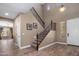 Bright foyer features staircase with iron railing, high ceilings, and wood-look tile flooring at 2614 E Carob Dr, Gilbert, AZ 85298