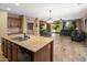 Open kitchen area featuring granite countertops, stainless steel appliances, and a seamless connection to the living room at 2614 E Carob Dr, Gilbert, AZ 85298