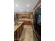 Chef's kitchen featuring granite counters, black appliances and wood look floors at 2614 E Carob Dr, Gilbert, AZ 85298