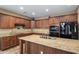 Modern kitchen featuring granite counters, black appliances and ample cabinet space at 2614 E Carob Dr, Gilbert, AZ 85298
