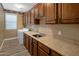 Spacious laundry room with ample counter space, sink, and a washing machine hookups at 2614 E Carob Dr, Gilbert, AZ 85298