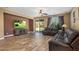 Comfortable living room featuring hardwood floors, a ceiling fan, and sliding glass doors to the backyard at 2614 E Carob Dr, Gilbert, AZ 85298