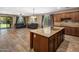 Open-concept living space featuring a modern kitchen and comfortable seating area with sliding glass doors to the patio at 2614 E Carob Dr, Gilbert, AZ 85298