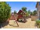 Backyard featuring a play structure with swings and slide on a mulch ground at 2614 E Carob Dr, Gilbert, AZ 85298