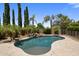 Backyard pool featuring stone accents and tropical landscaping at 2614 E Carob Dr, Gilbert, AZ 85298