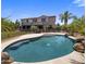 A backyard swimming pool sits in front of a two-story house at 2614 E Carob Dr, Gilbert, AZ 85298