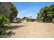 Spacious backyard featuring a covered patio, mature trees, and ample space for outdoor activities at 2921 N 103Rd Ave, Avondale, AZ 85392