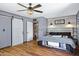 Cozy bedroom with wood-style flooring, white sliding door, and accent wall at 2921 N 103Rd Ave, Avondale, AZ 85392