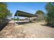 Large Carport with a clear exit area. A two story barn is shown in the back at 2921 N 103Rd Ave, Avondale, AZ 85392