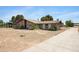 Beautiful brick home showcasing a unique design, surrounded by natural landscaping, epitomizing tranquil desert living at 2921 N 103Rd Ave, Avondale, AZ 85392