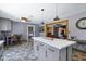 Kitchen with island, gray cabinets, stainless appliances, eat in kitchen, and open dining space at 2921 N 103Rd Ave, Avondale, AZ 85392