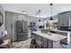 Stylish kitchen with modern appliances, custom gray cabinetry, island, and sleek countertops at 2921 N 103Rd Ave, Avondale, AZ 85392